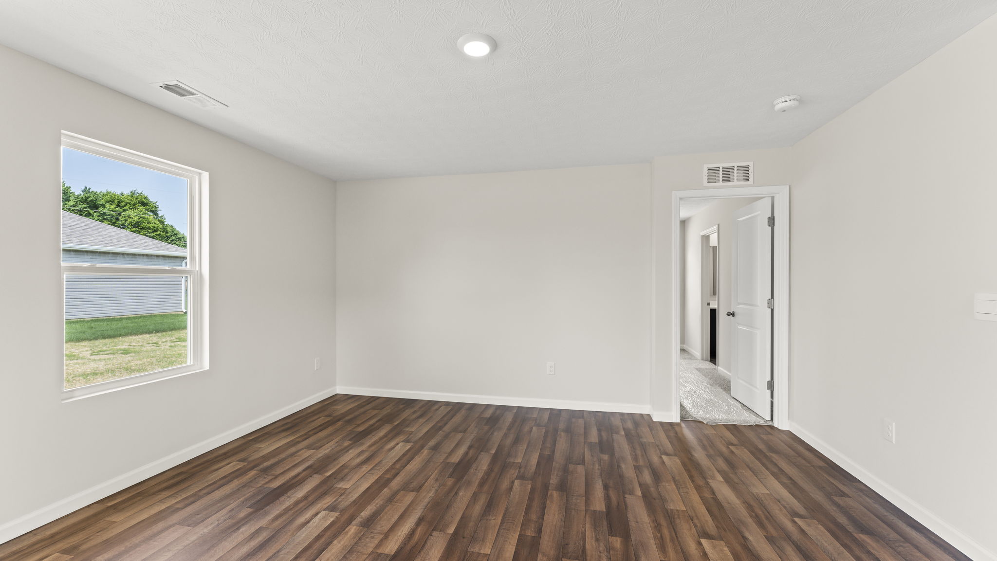Living room with several windows for natural lighting.