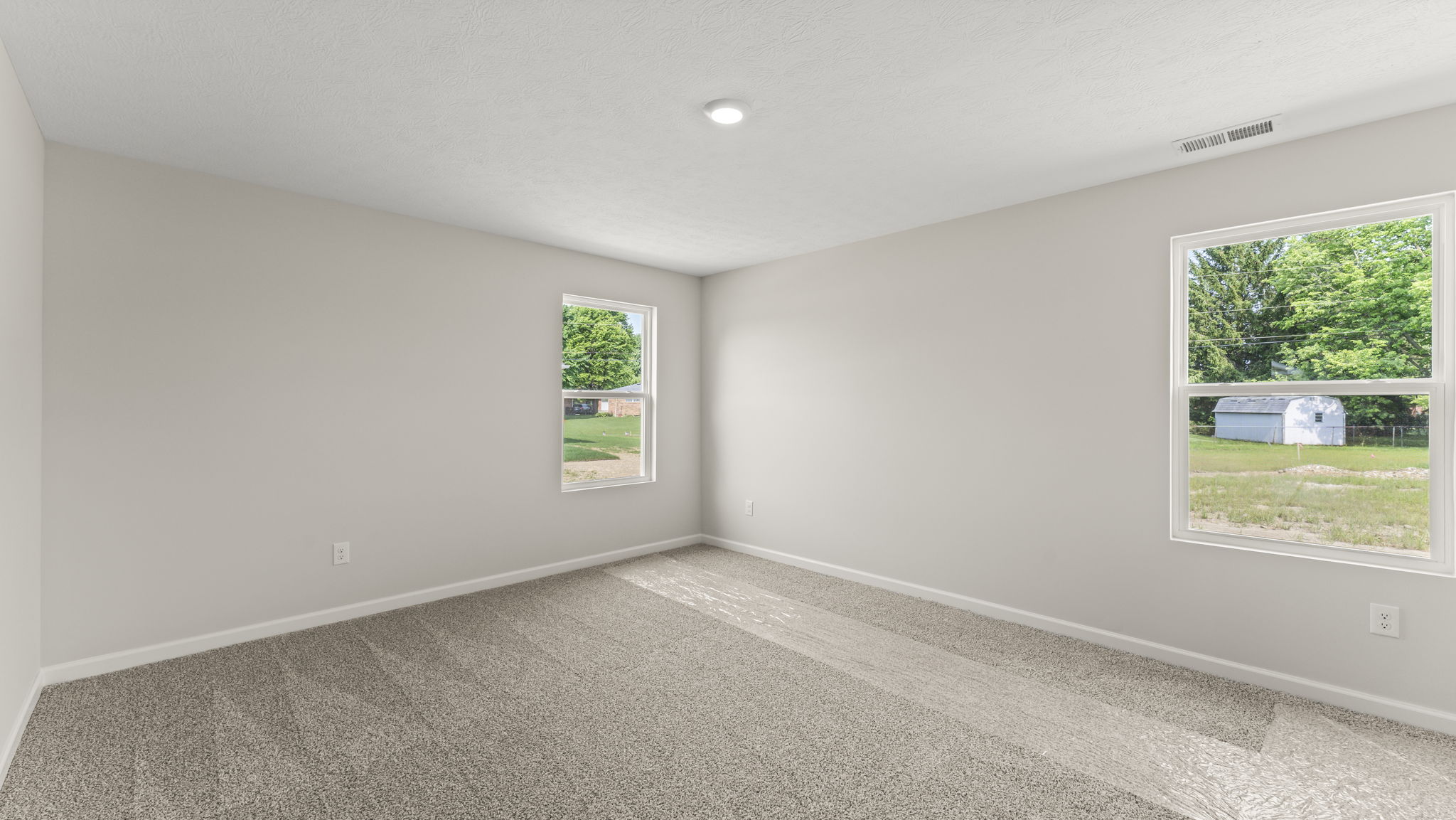 Bedroom with several windows.