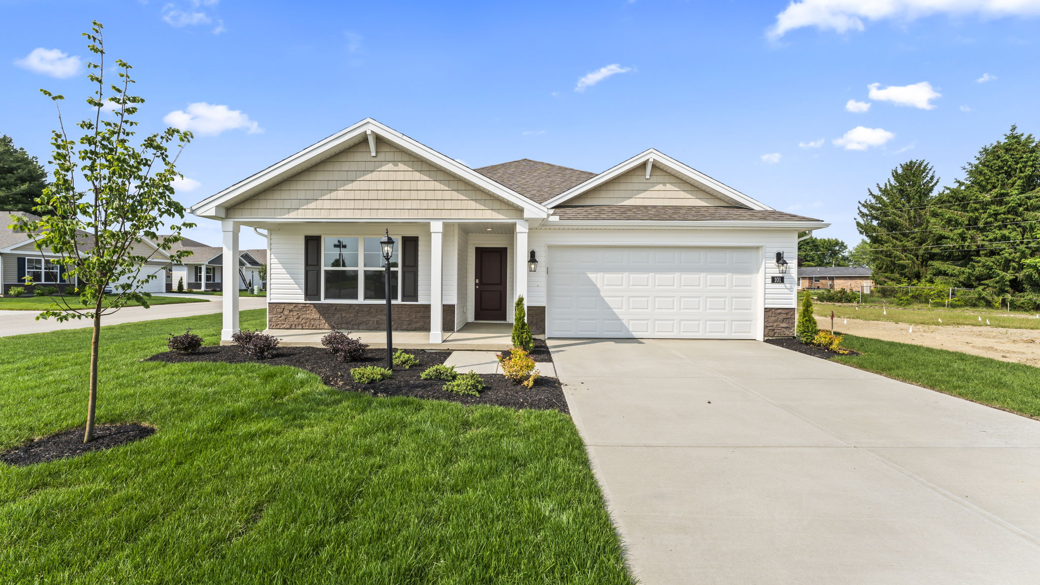 Front exterior of home with partial brick siding.