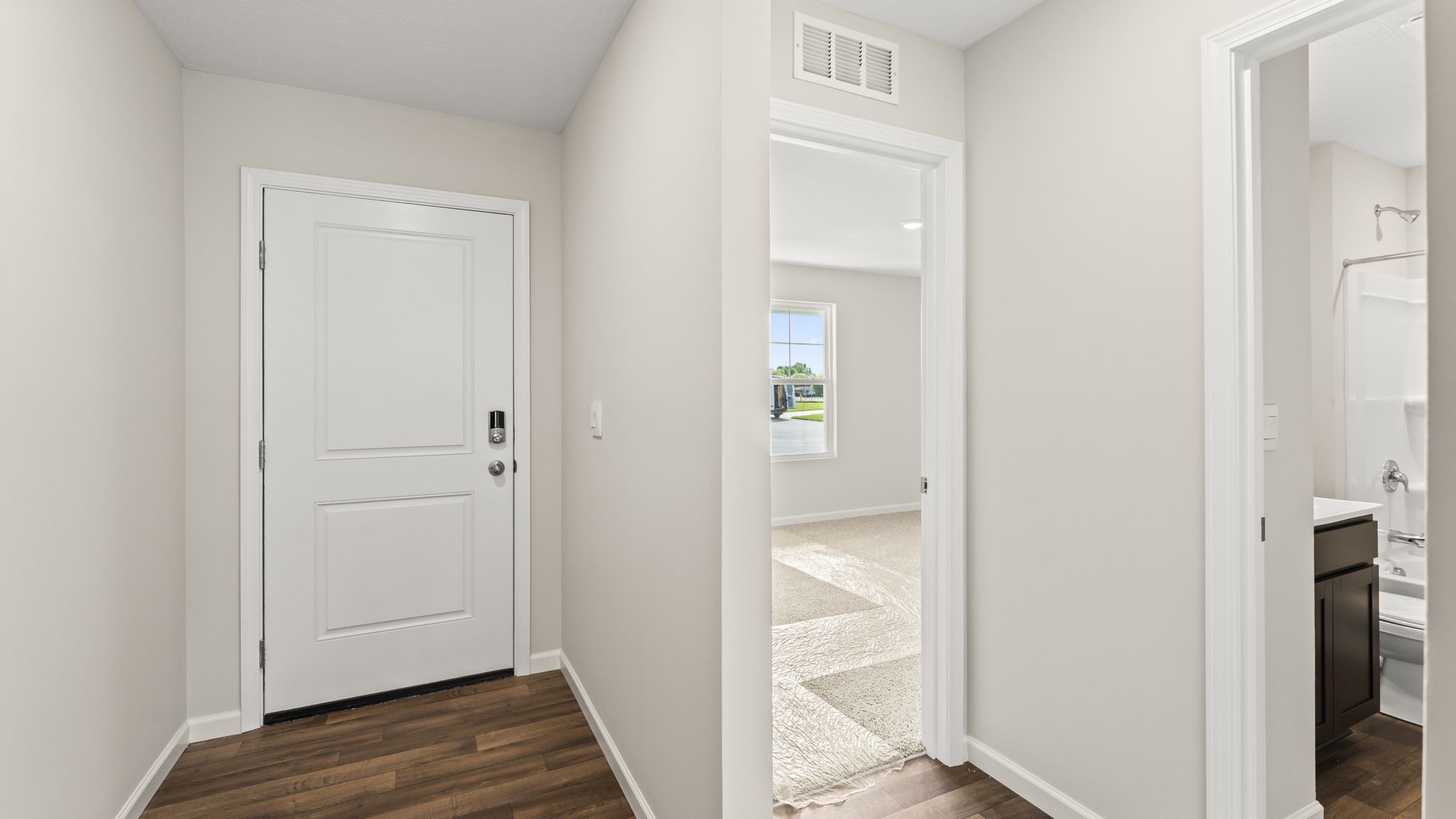 Hallway in between a bathroom and bedrooms.
