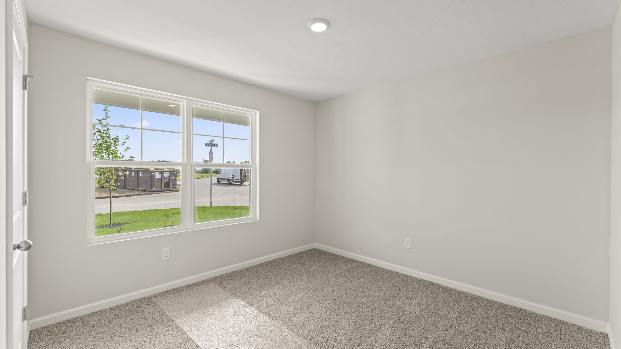 Bedroom with a large window.