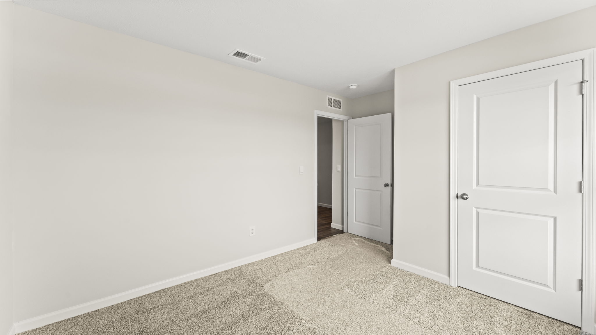 Bedroom with carpeted floors and a large closet.