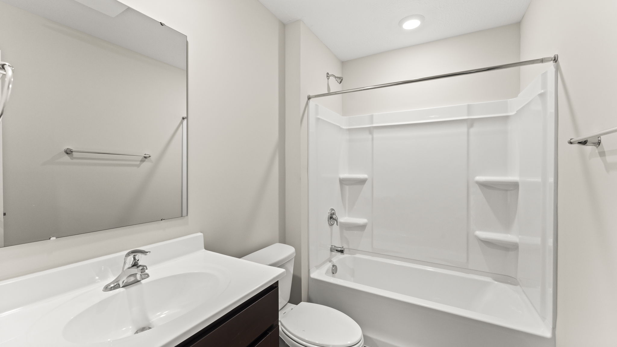 Bathroom with a single vanity sink and a step in shower.
