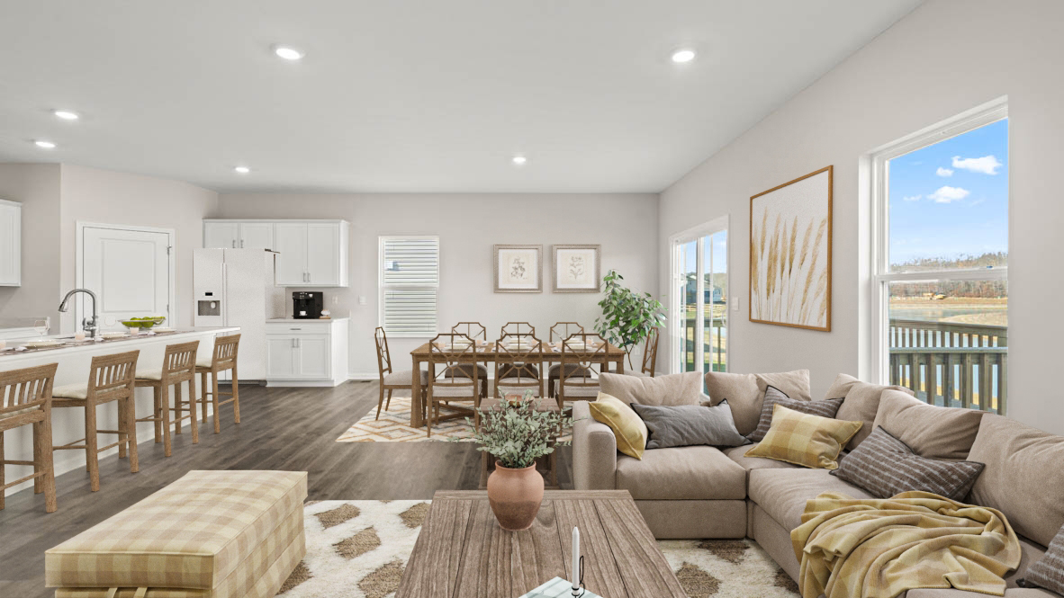 Living room, dining room, and kitchen with modern open concept decorated with sleek modern art.