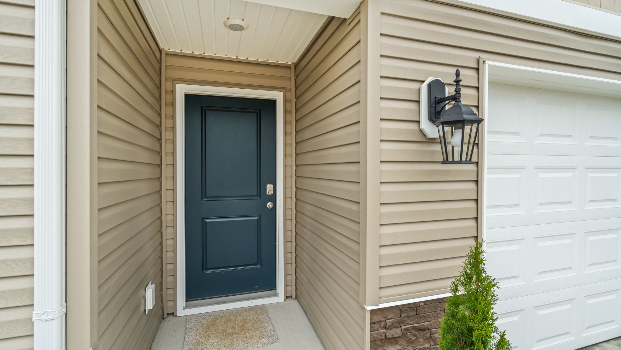Front exterior of home with partial brick siding.