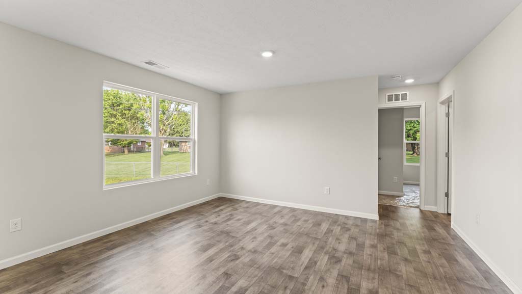 Living room with large window for natural lighting.