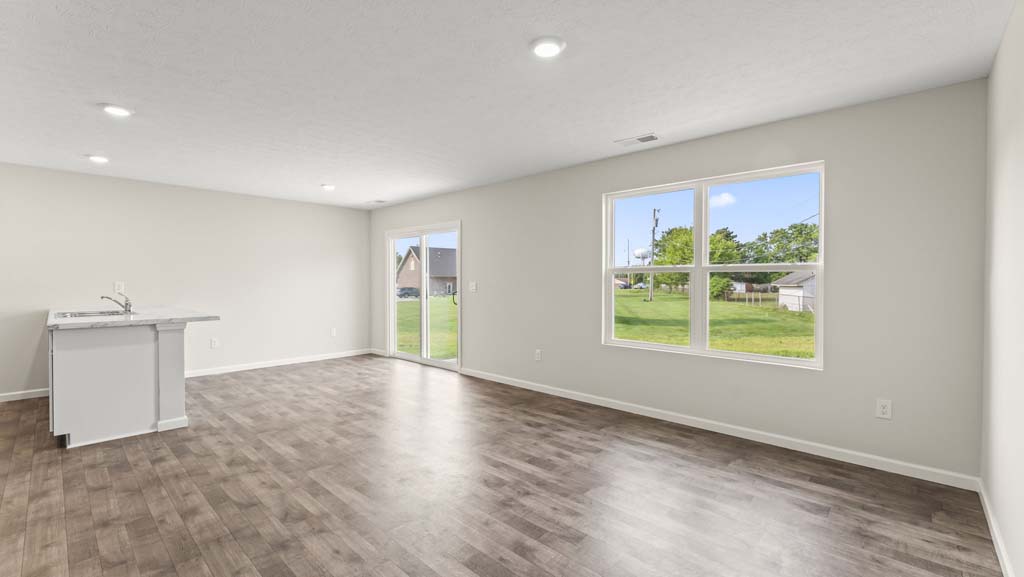 Living room with large window for natural lighting.
