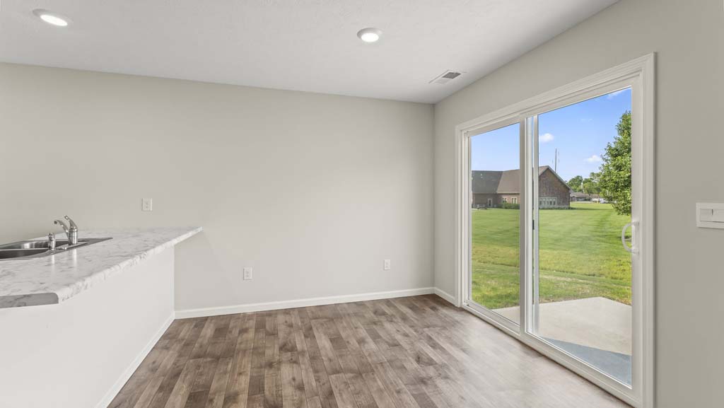 Dining area with direct access to backyard through glass sliding doors.