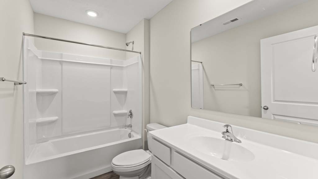 Bathroom with a single vanity sink and step in shower.