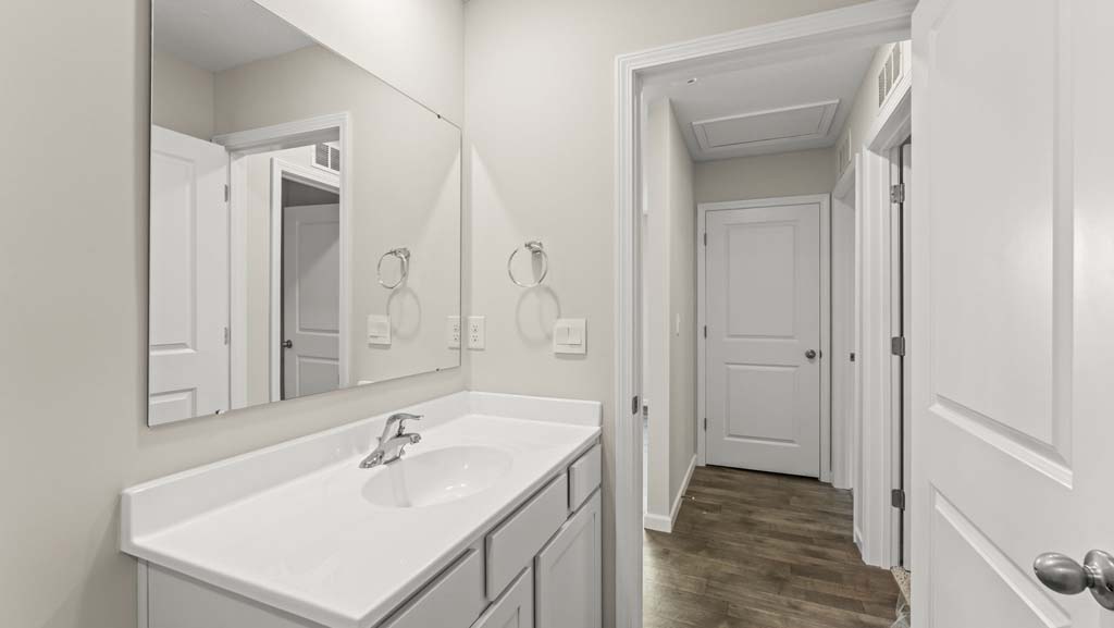 Bathroom with gray cabinetry.