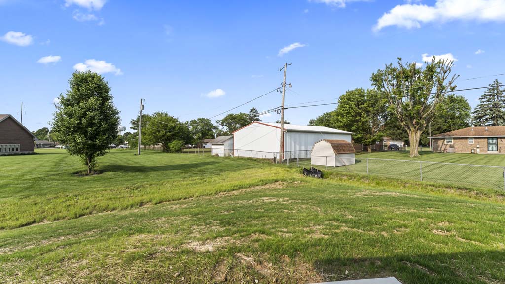 View of backyard with luscious grass.