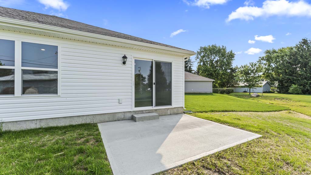 Backyard with a concrete porch.