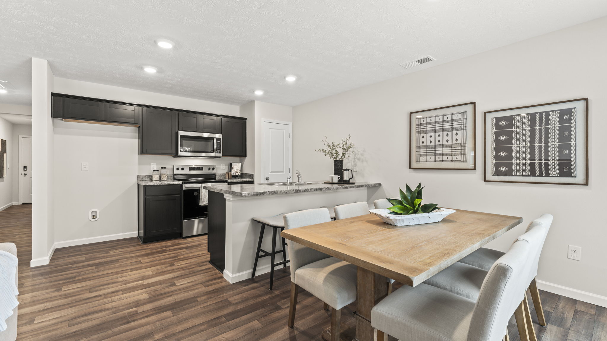 Dining room in your new home showcases our stylish open concept connectivity to main areas, outdoors, front entry