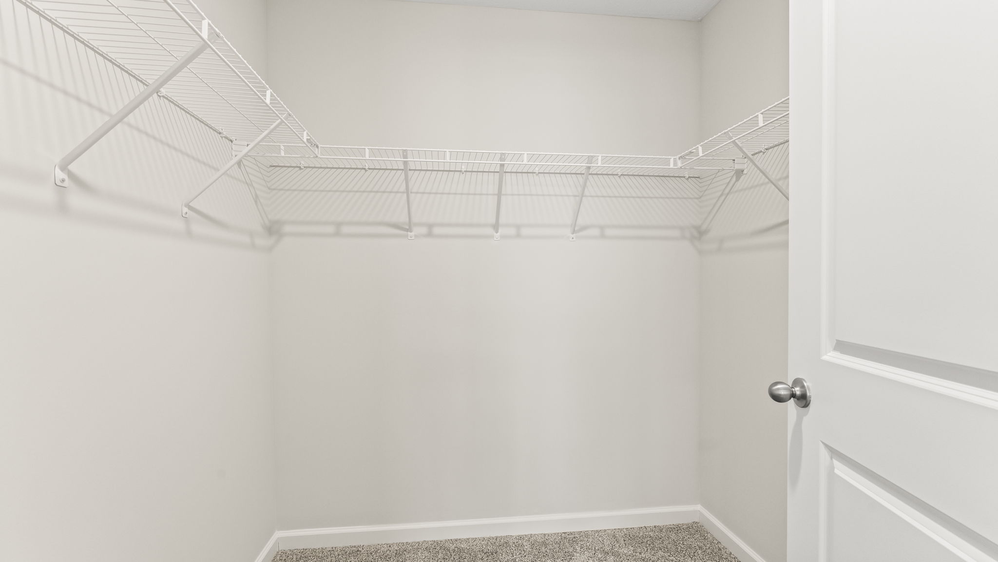 Interior view of the walk-in closet connected to the primary bedroom with spa-inspired ensuite and generous storage