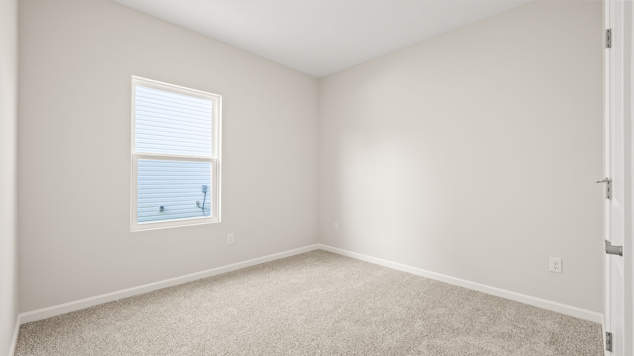 Carpeted bedroom with window