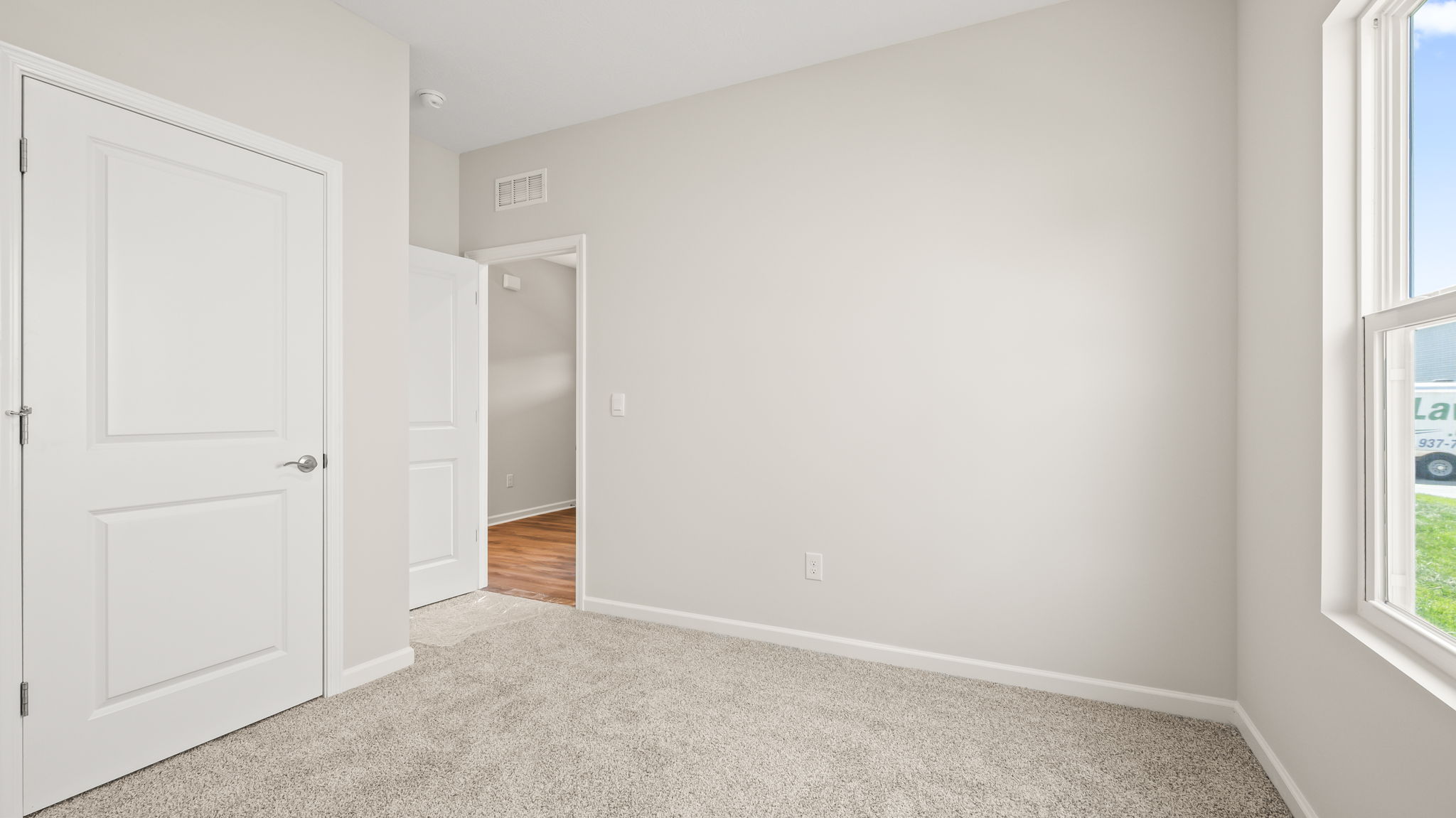 Carpeted bedroom with window