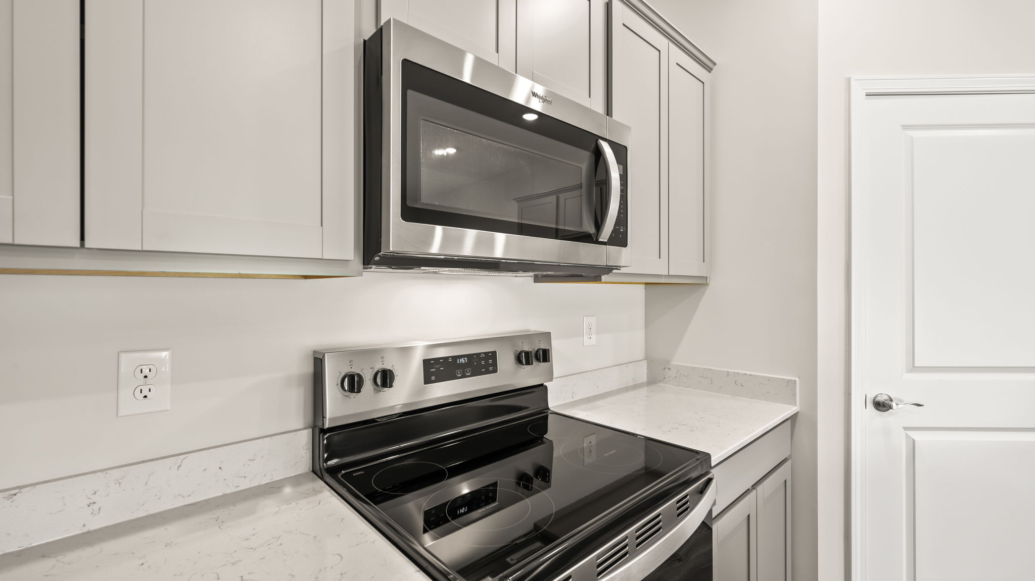 Closeup of oven range between cabinets