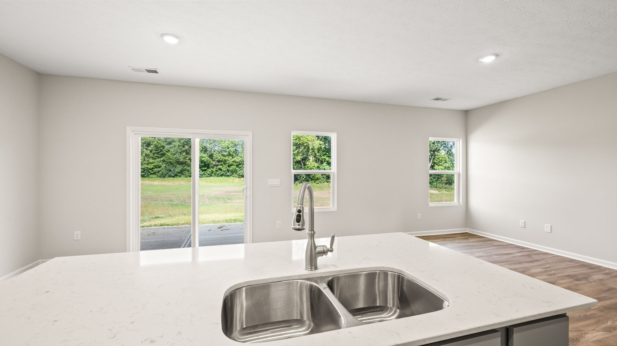 First person perspective angle image with view of kitchen island and sink
