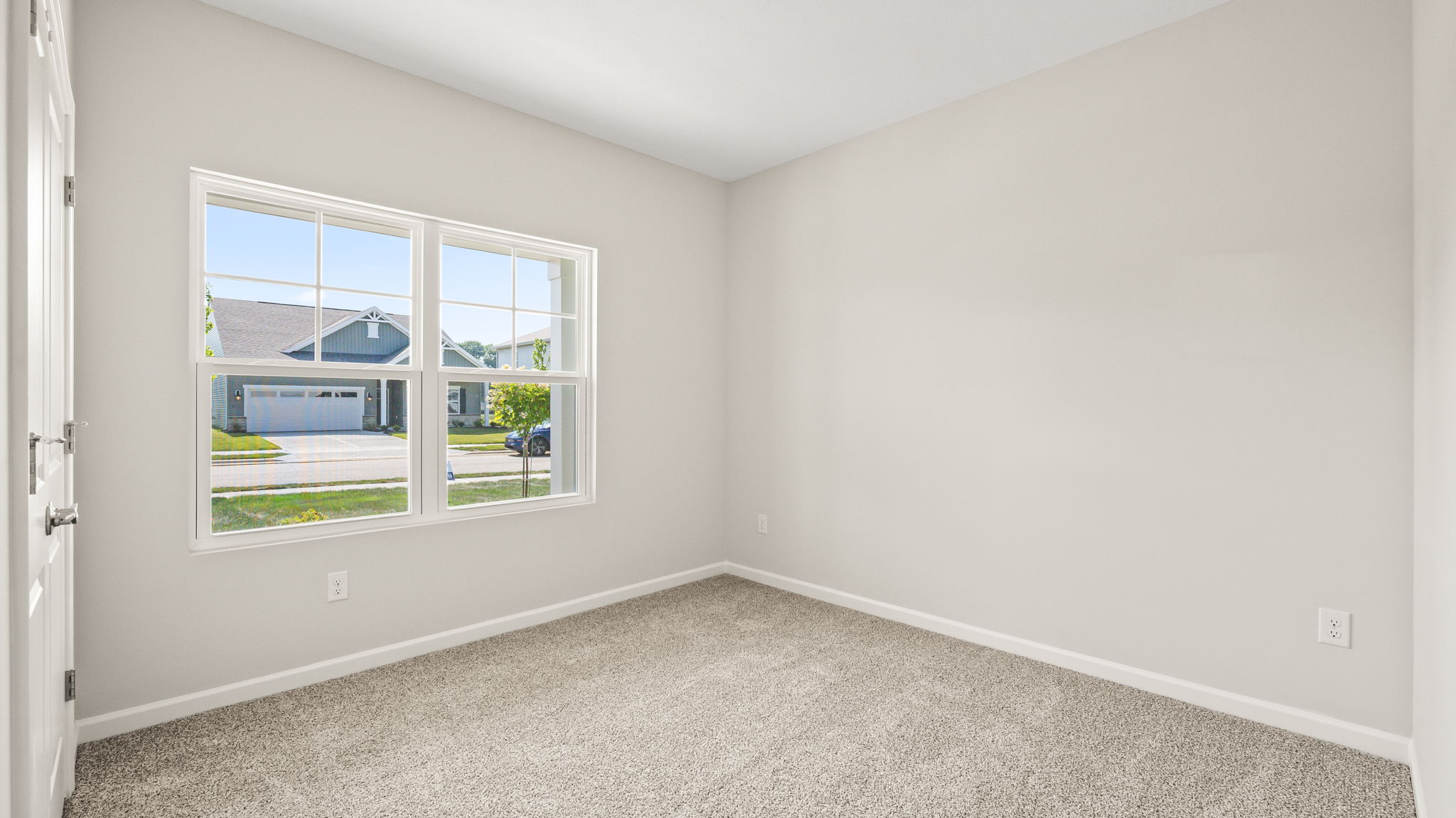 Carpeted bedroom with window