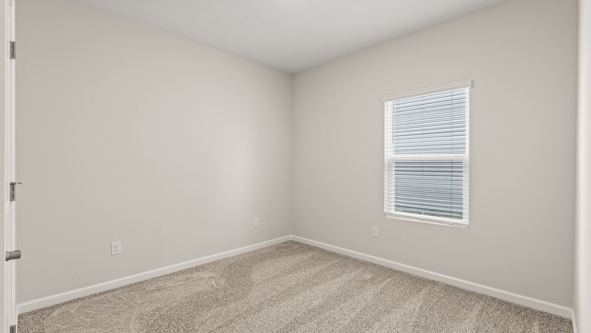 Carpeted bedroom with window