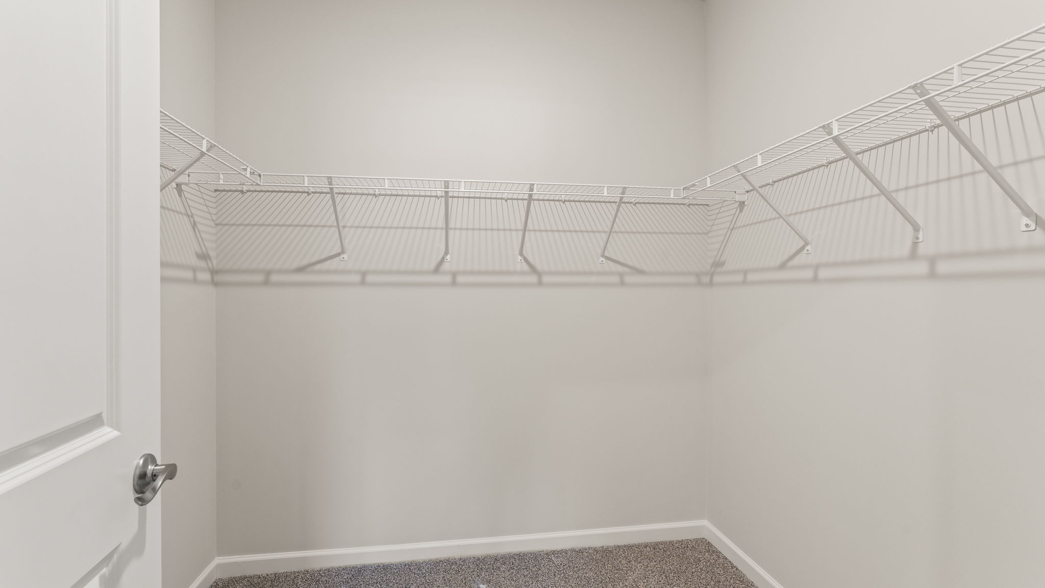 Walk-in closet with wire rack shelving.