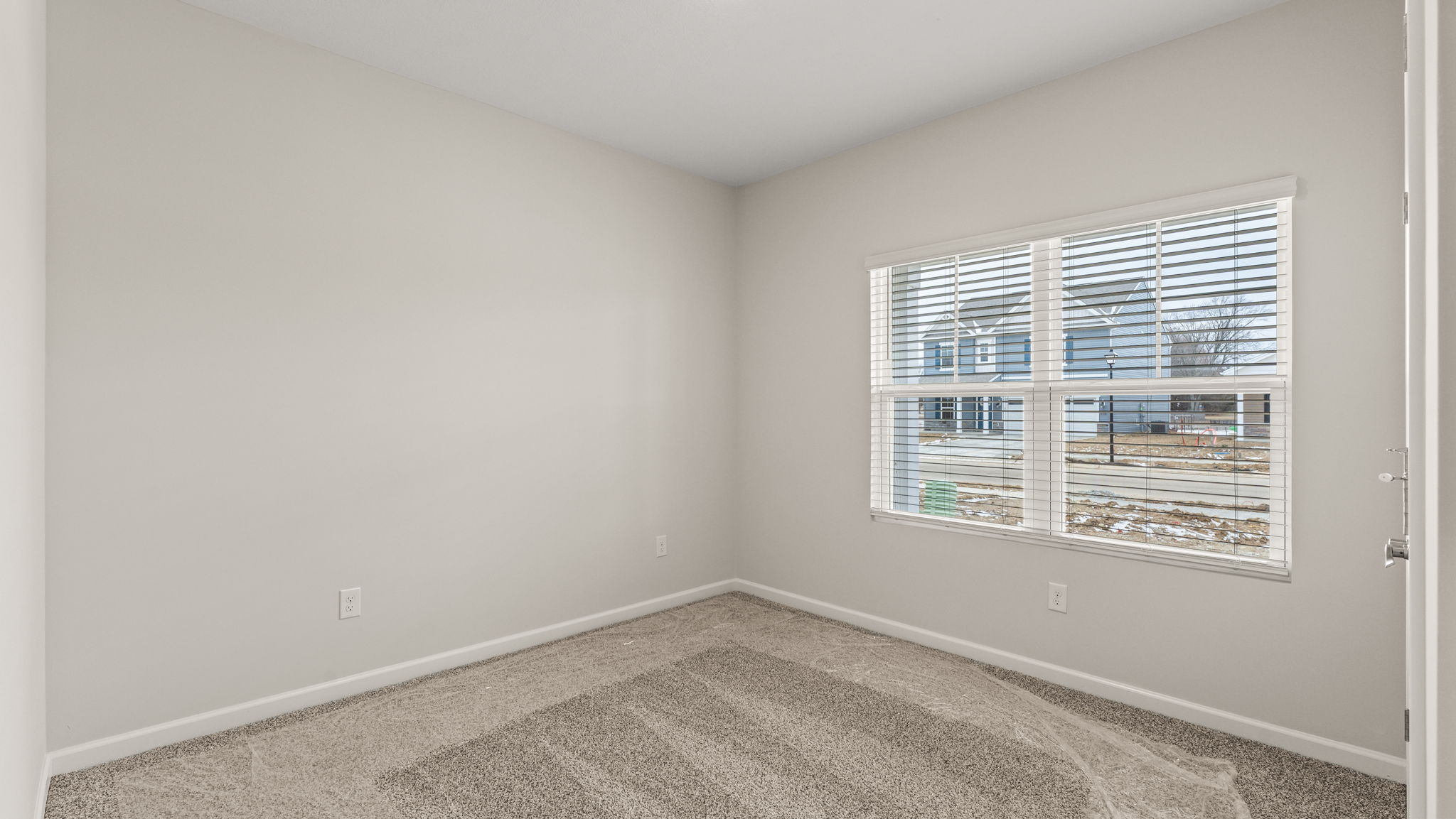 Carpeted bedroom with window