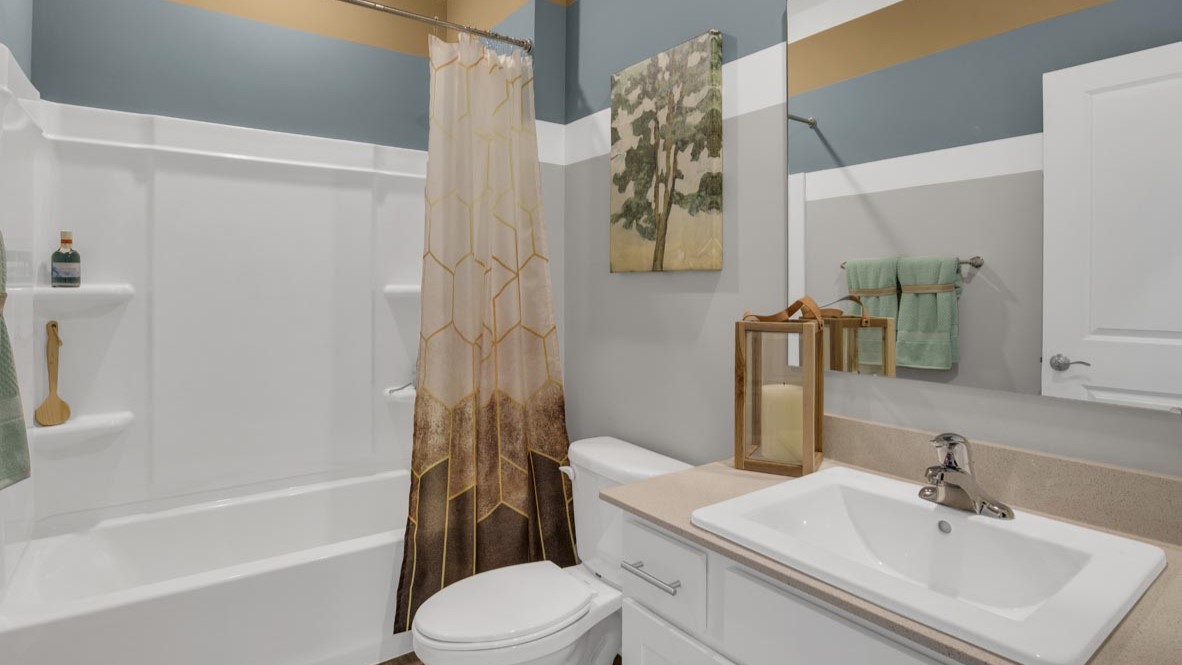 shared bathroom with shower, toilet, and sink.