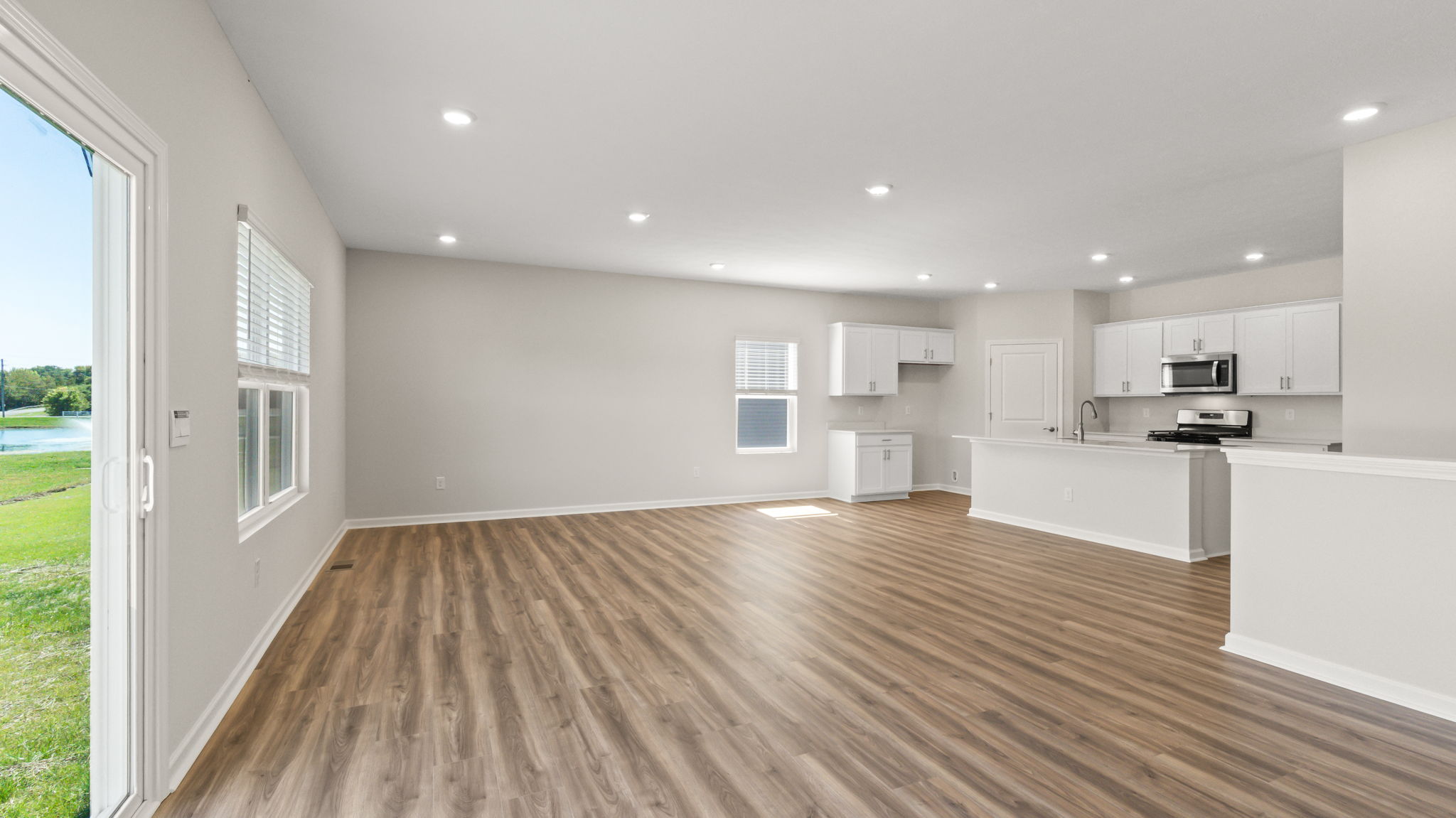 wide angle image of full open concept great room and kitchen