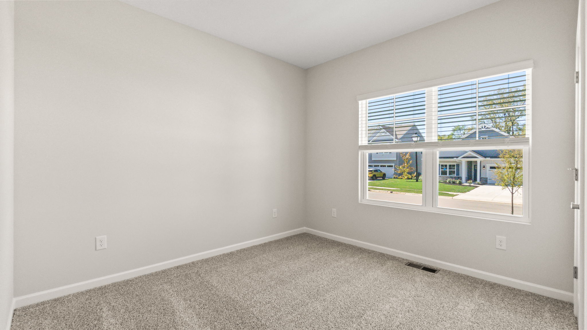 Carpeted bedroom with window