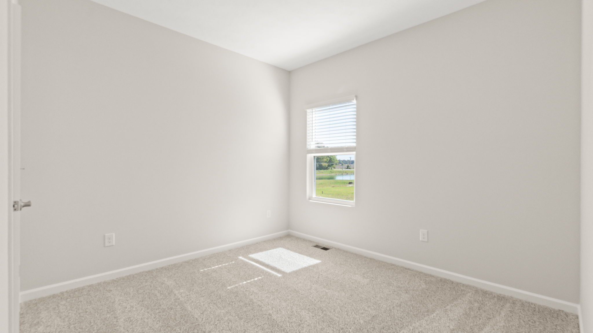 Carpeted bedroom with window