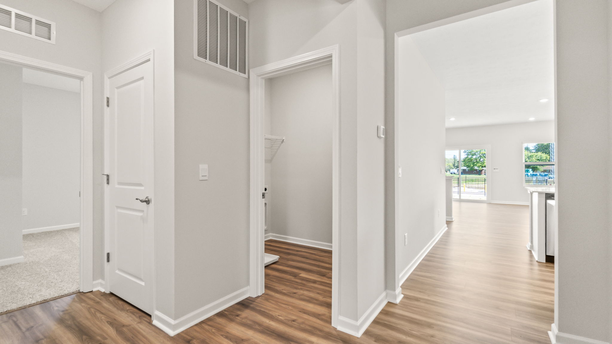 foyer leading to bathroom, laundry area, and great room