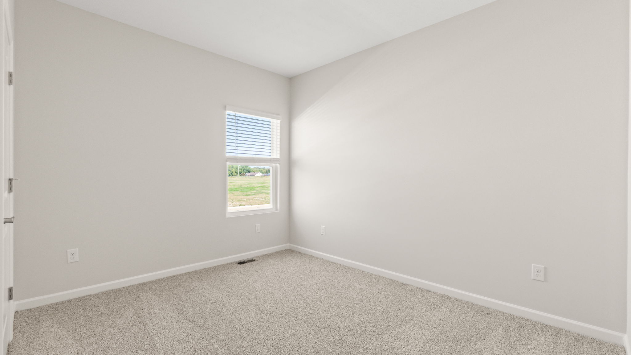 Carpeted bedroom with window