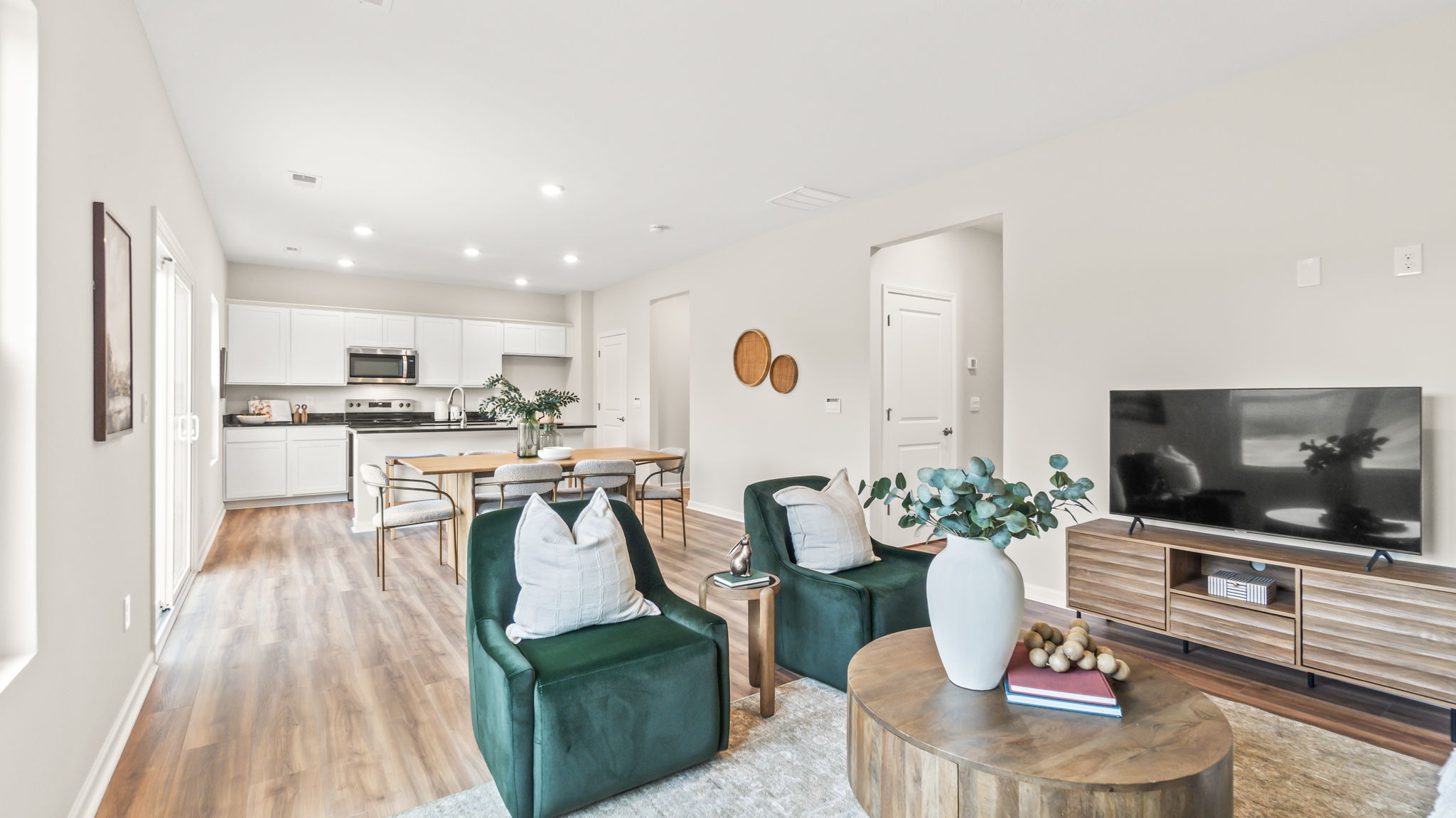 Perspective image of the full kitchen, dining, and living room areas