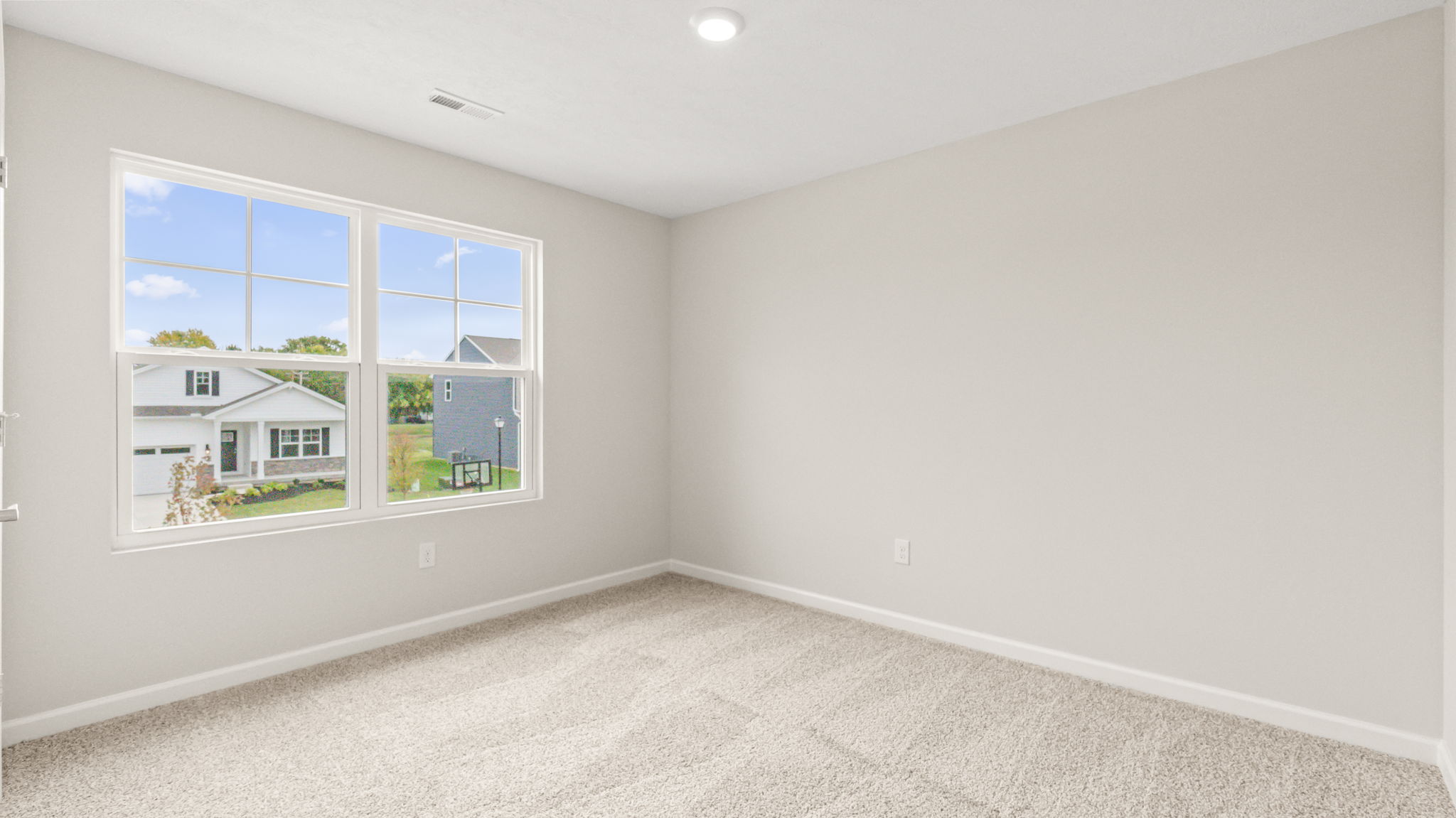 Carpeted bedroom with window