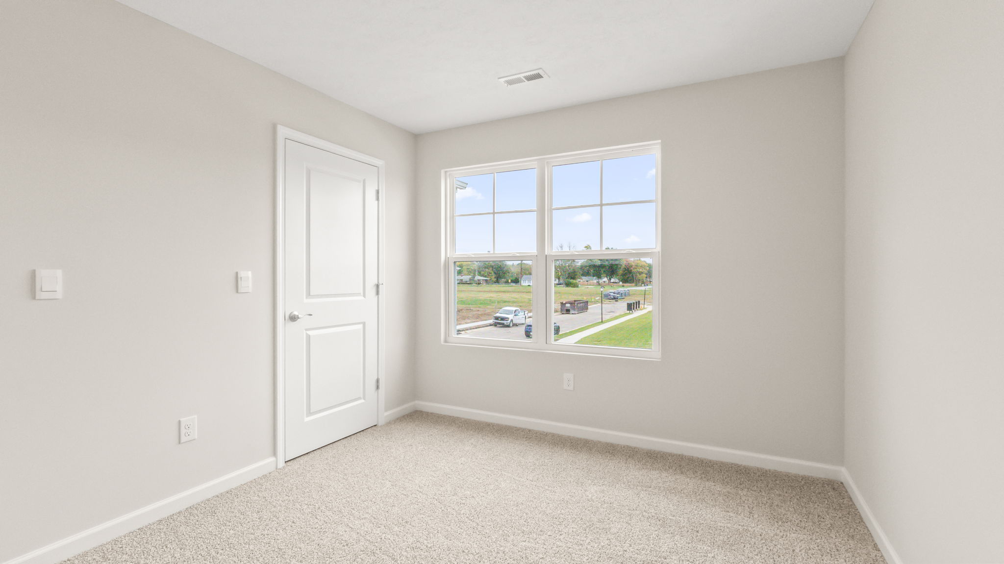 Carpeted bedroom with window