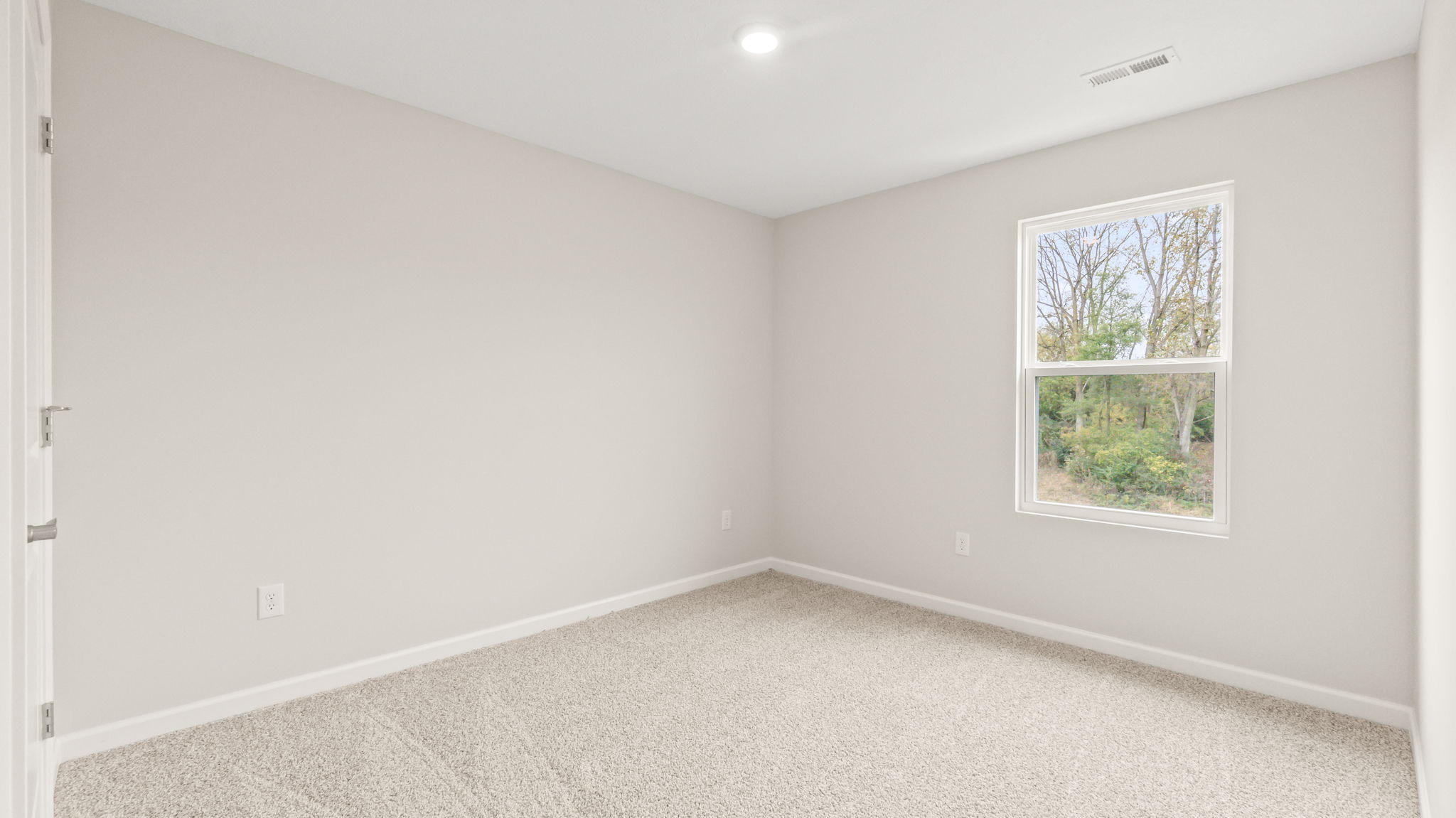 Carpeted bedroom with window