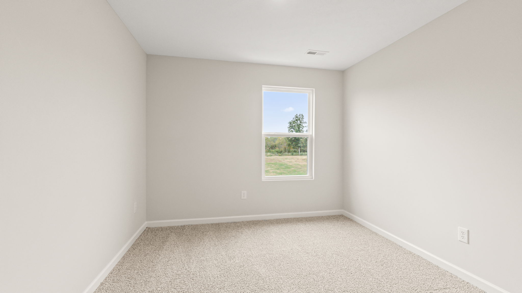 Carpeted bedroom with window