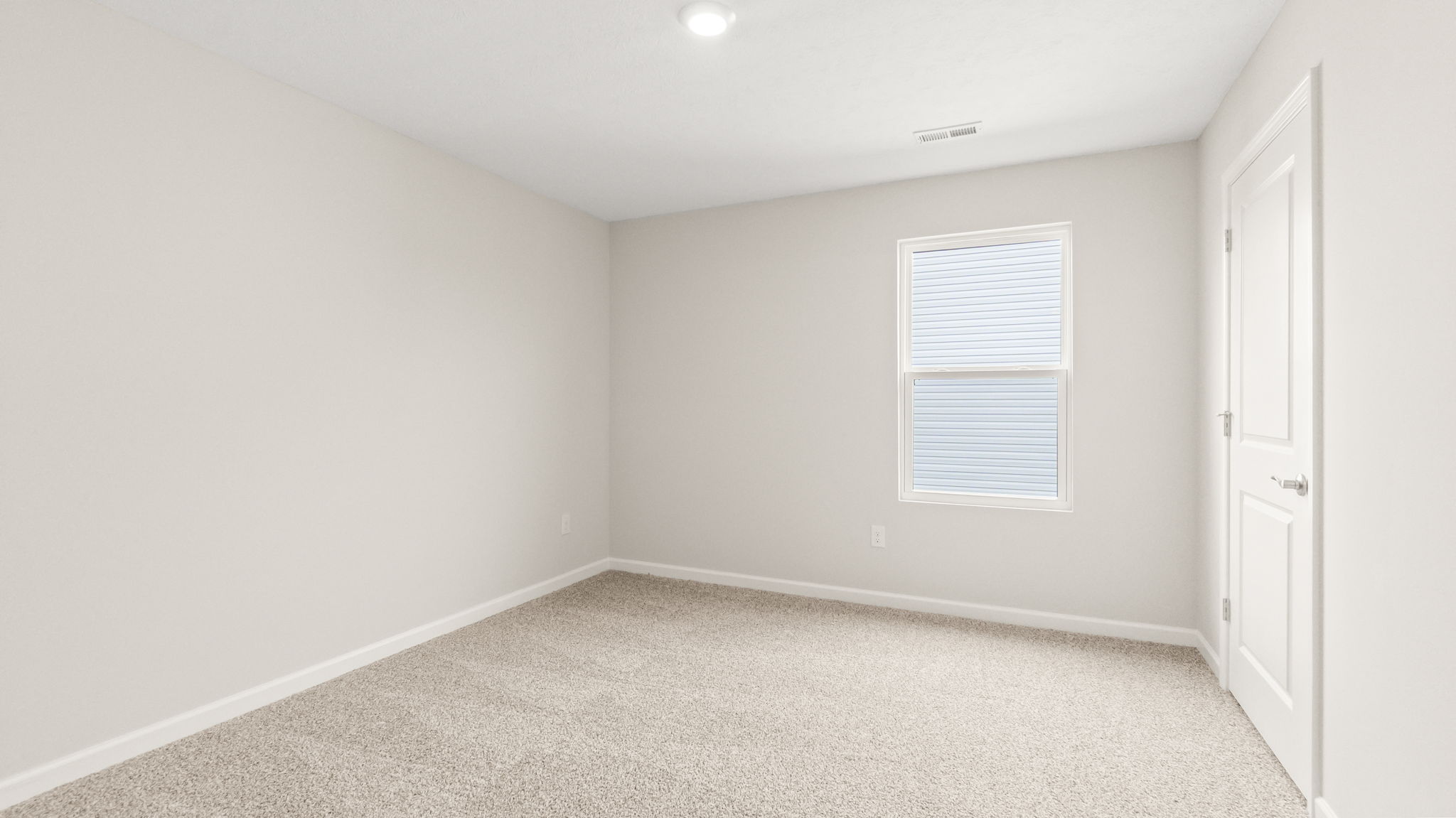 Carpeted bedroom with window