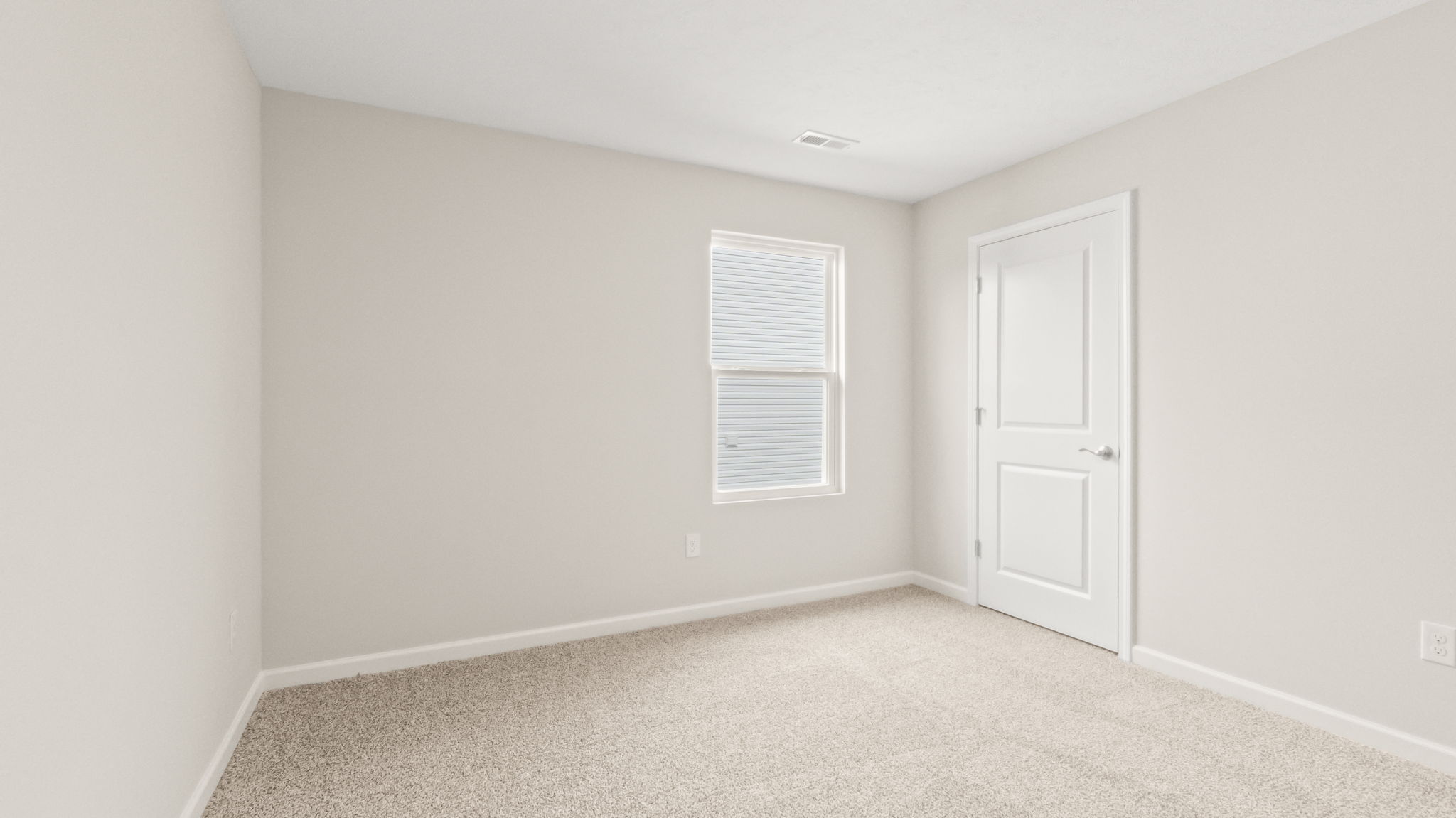 Carpeted bedroom with window