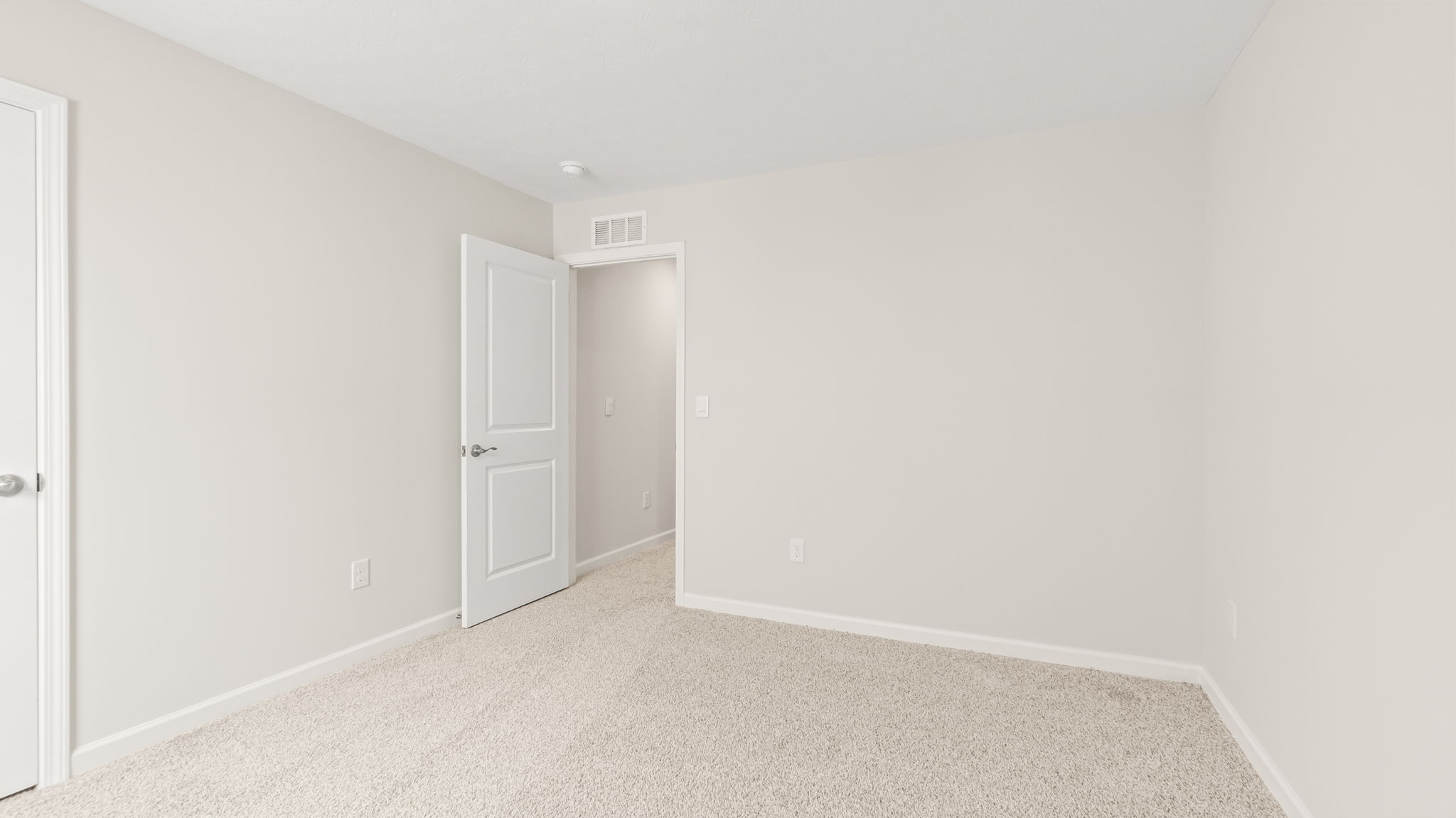Carpeted bedroom with window