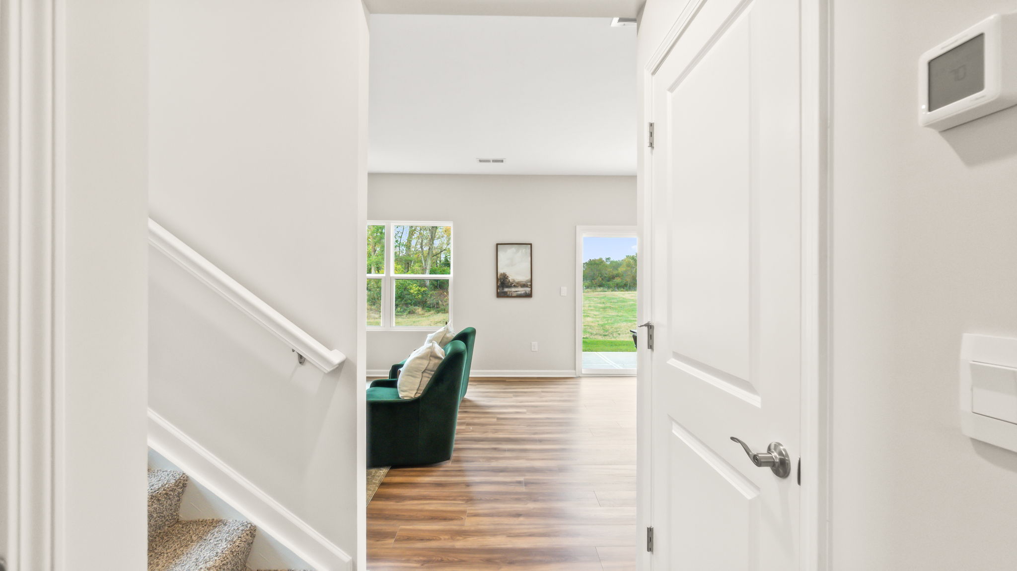 Downstairs foyer with view of stairs going up and living room