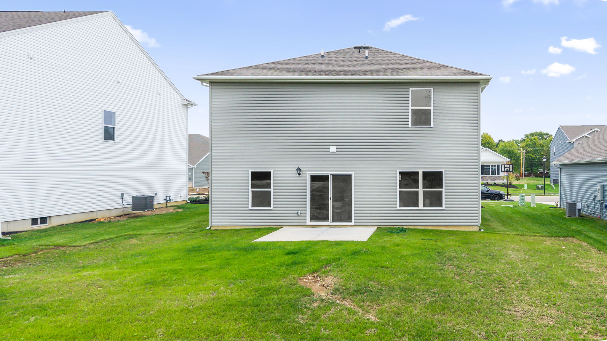 Rear of home with grass and patio