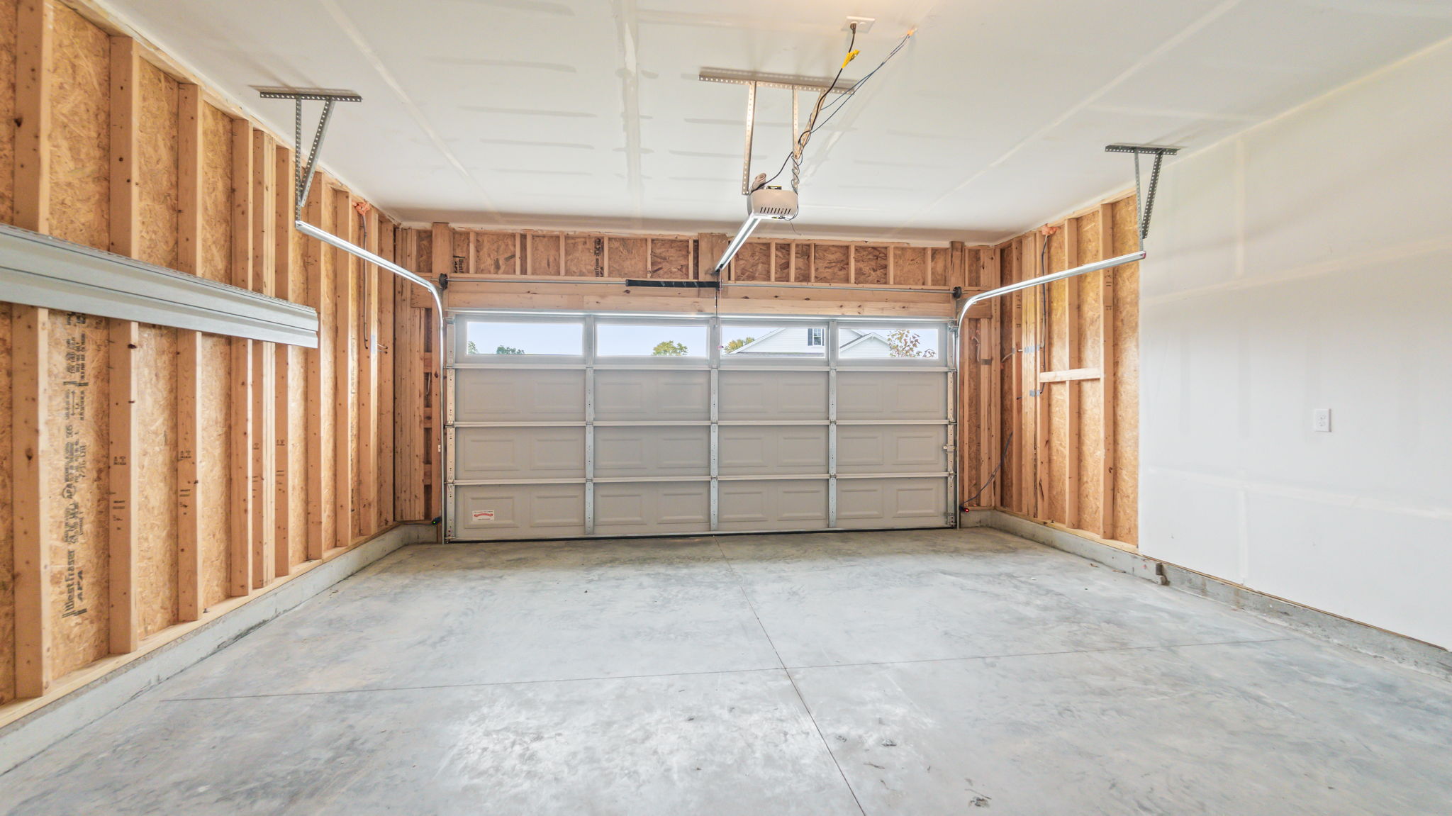 2-car garage with garage door with window cutouts.