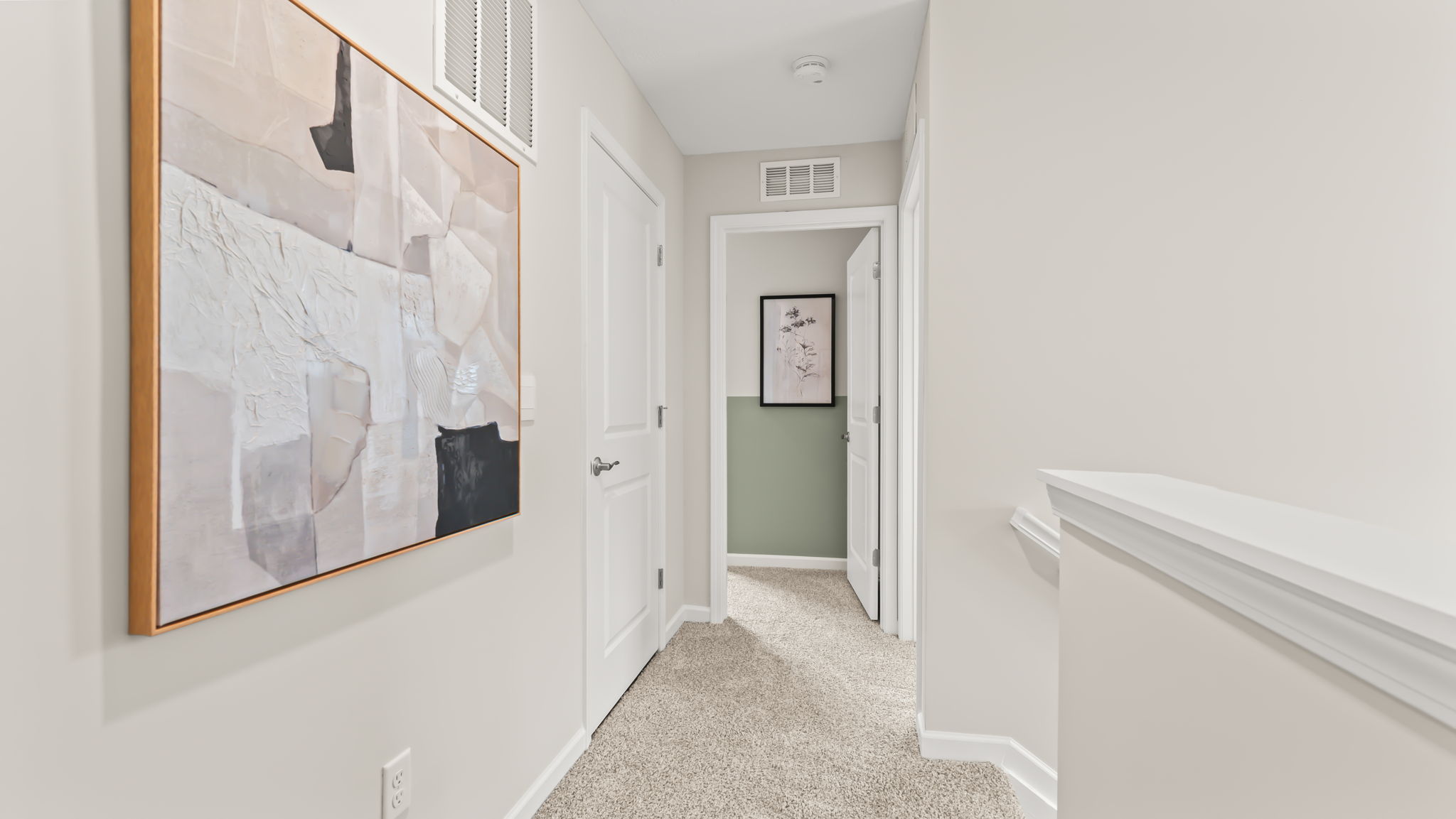 Upstairs hallway with abstract block art on the wall