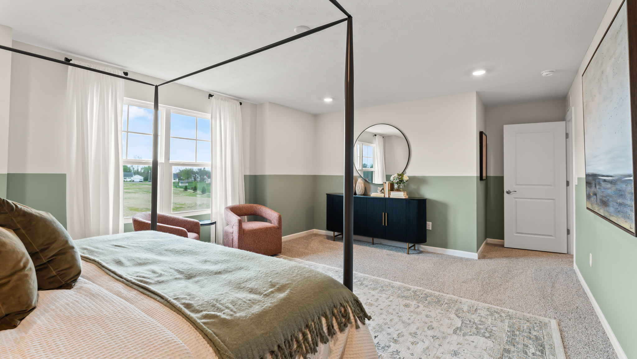 Closeup of the primary bed with view of dresser drawer and window