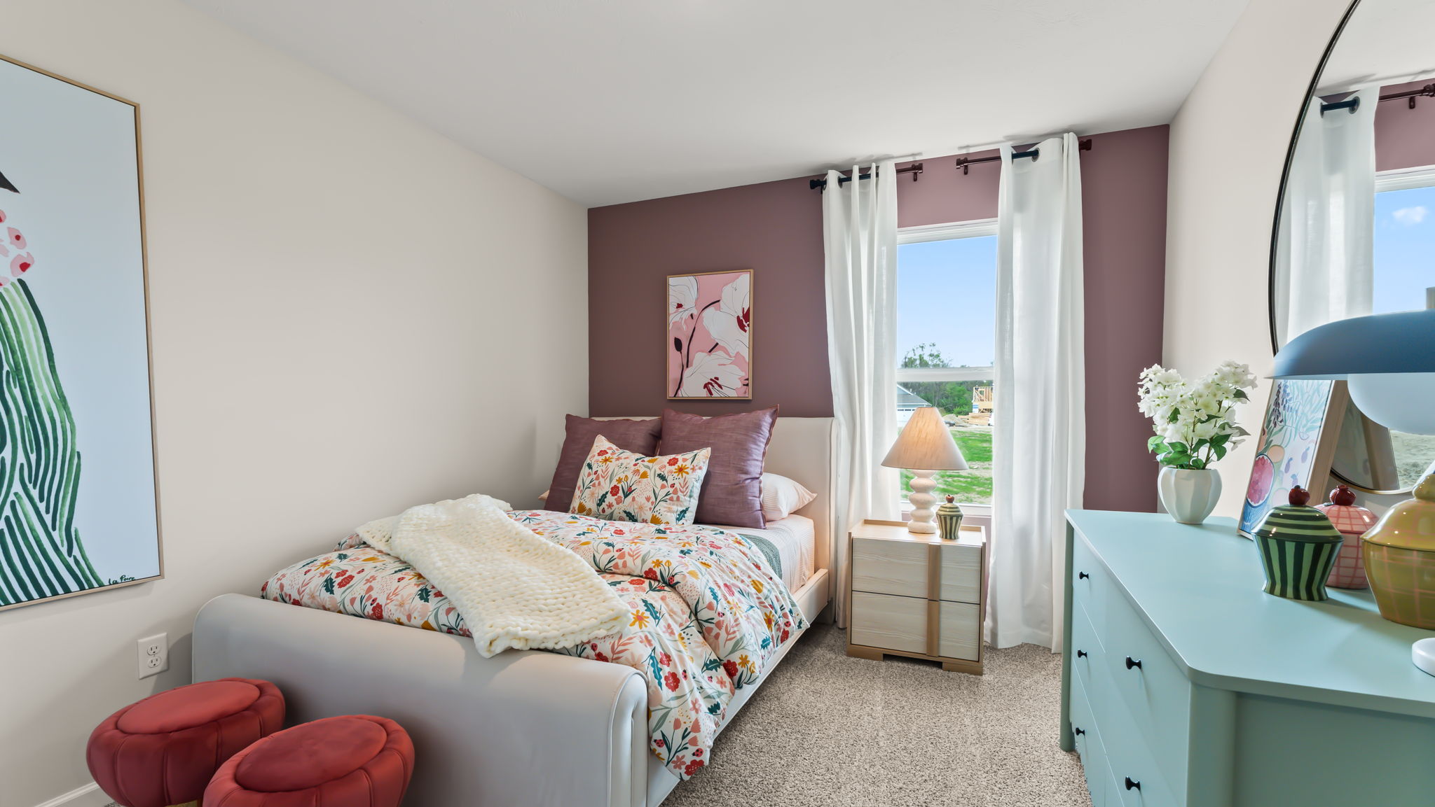 Bedroom with pastel green and purple furniture containing polka dot bedding