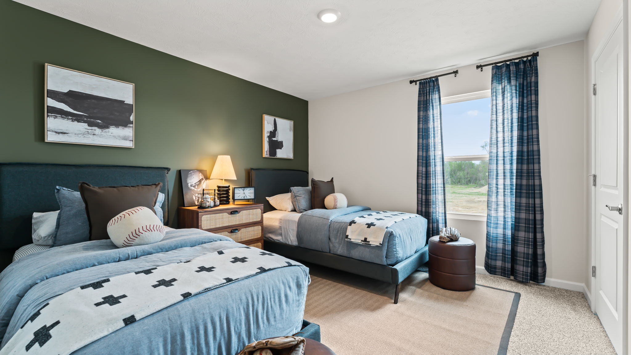 Bedroom containing twin beds and baseball theme