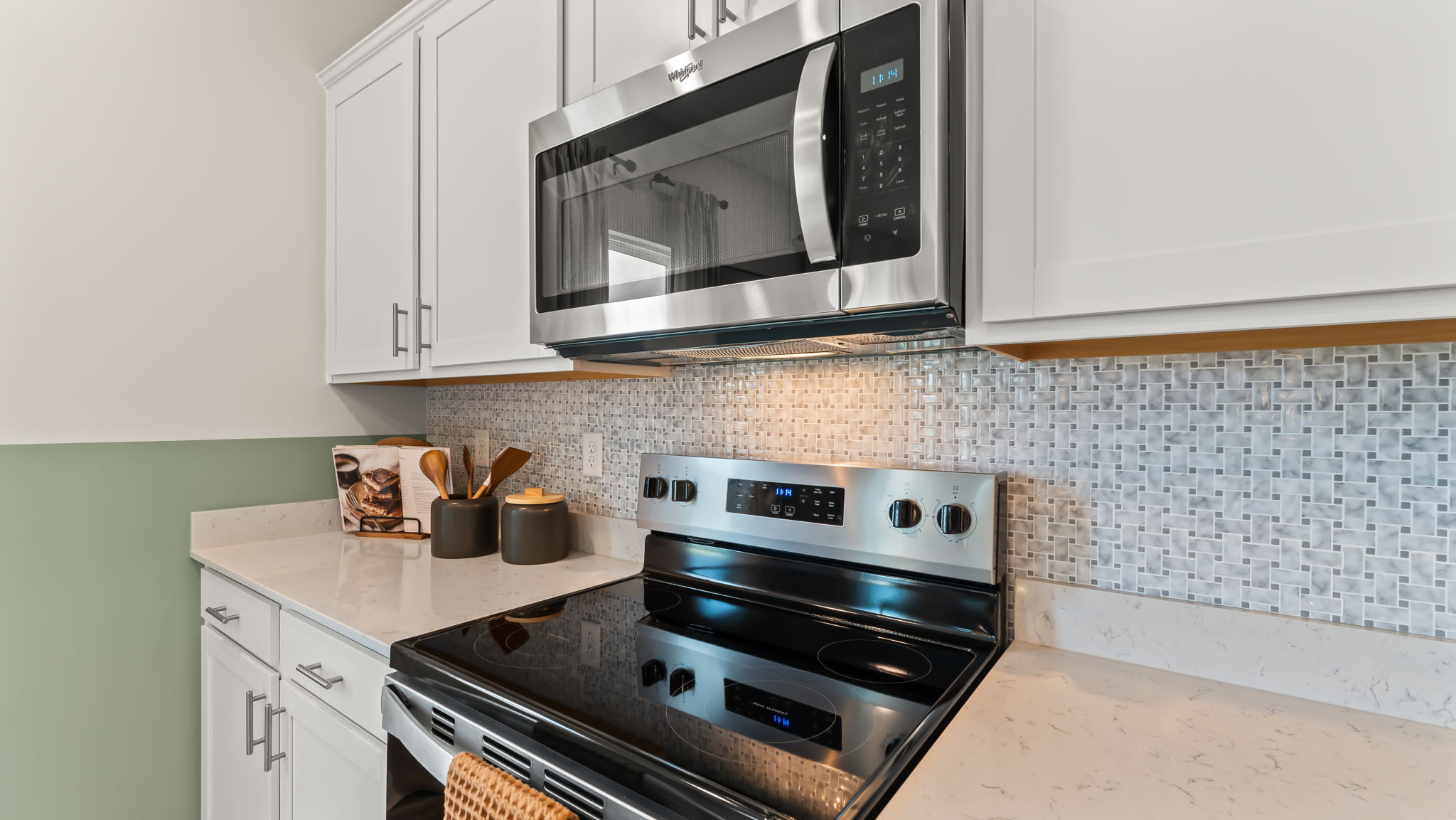Closeup of kitchen oven range between quartz countertops