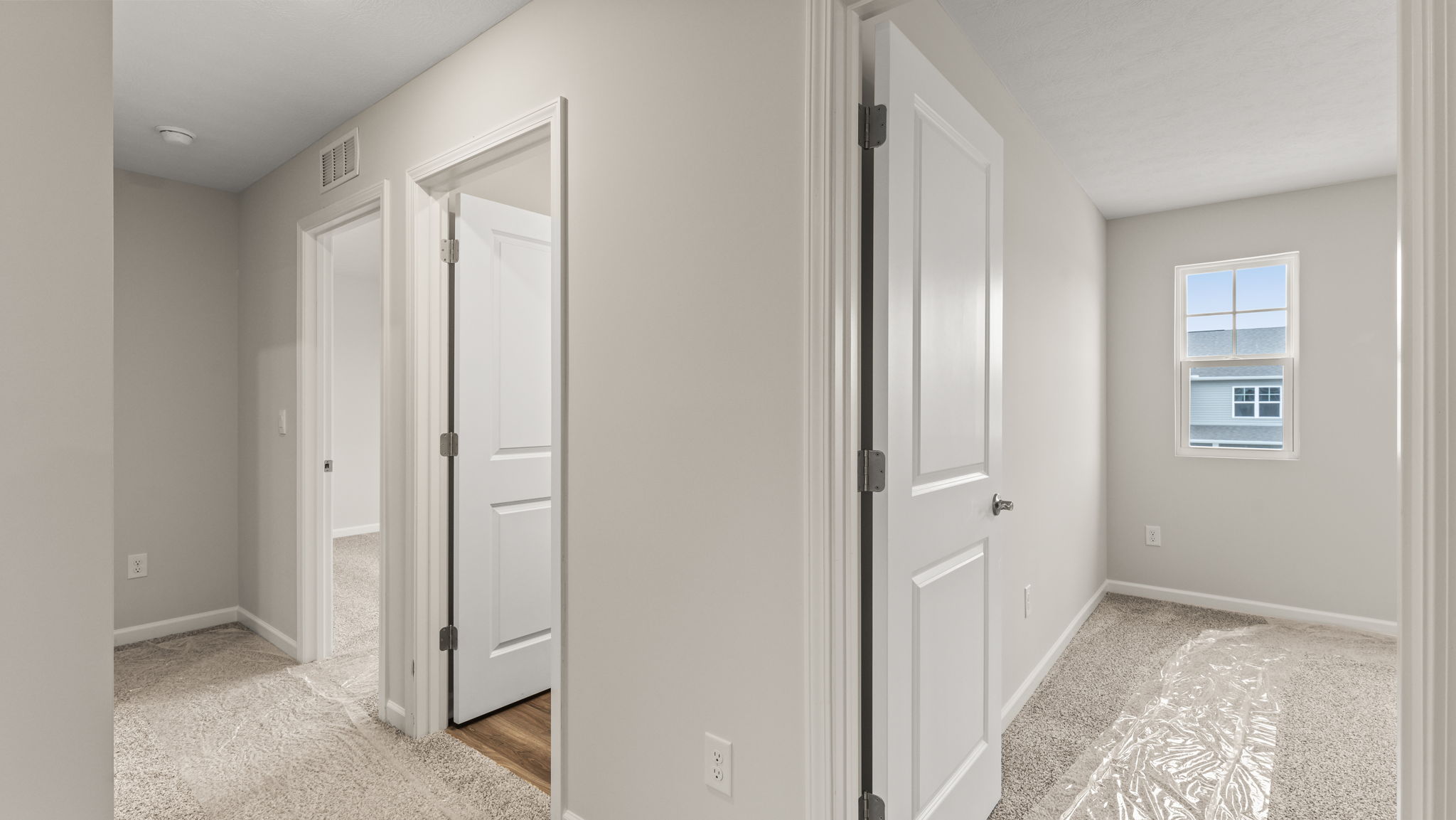 Hallway with doors to bedroom and bathroom
