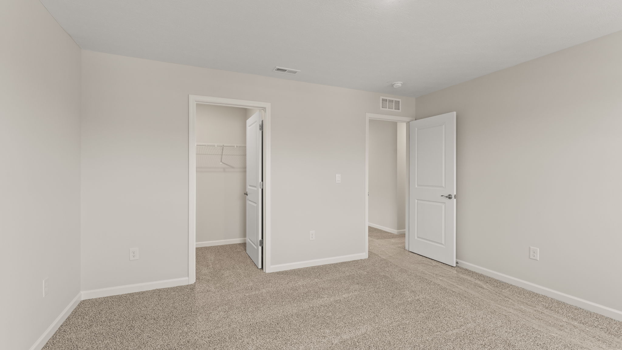 Carpeted bedroom with closet